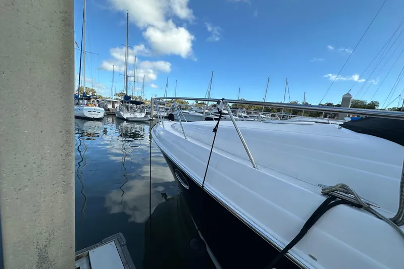 Slide: The Image of 2008 Regal Commodore 4060 yacht docked in a marina under a clear blue sky. - 9
