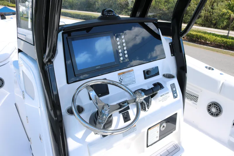 Slide: The Image of 2026 Sea Fox 268 Commander boat dashboard with steering wheel and navigation display. - 10