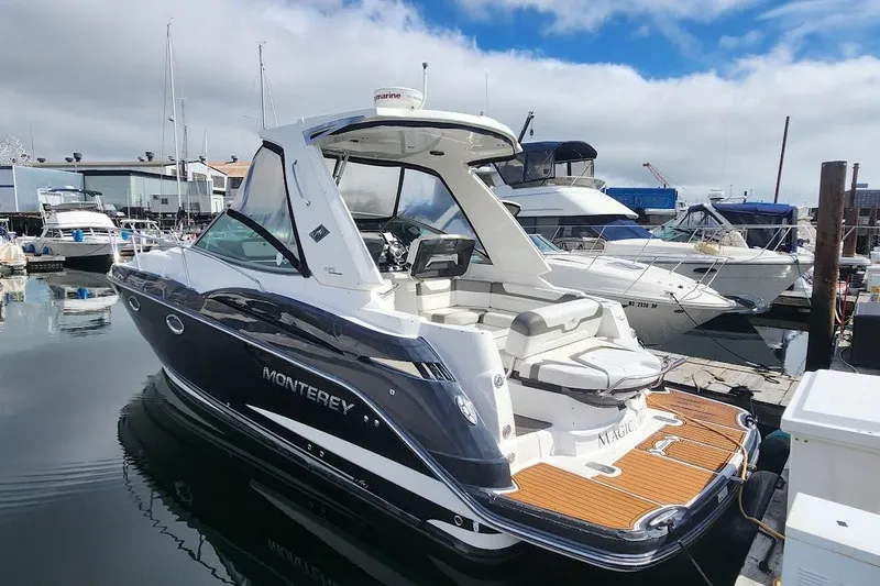 The Image of 2015 Monterey 335 Sport Yacht docked at marina, sleek design, luxury features. - 0