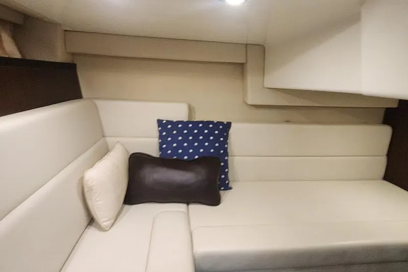 Slide: The Image of 2015 Monterey 335 Sport Yacht interior with beige seating and decorative pillows. - 11
