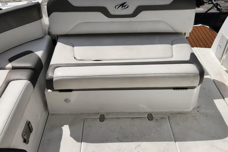 Slide: The Image of 2015 Monterey 335 Sport Yacht interior seating with white and gray upholstery. - 12
