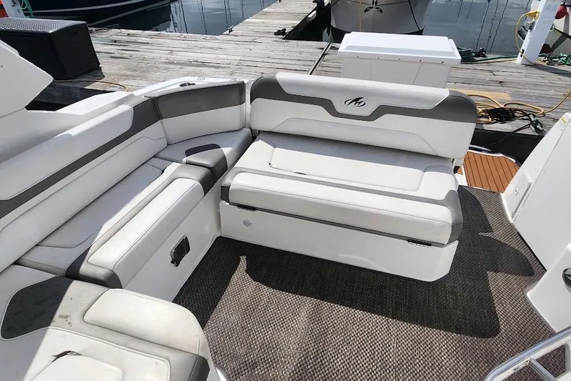 Slide: The Image of 2015 Monterey 335 Sport Yacht interior seating with gray and white upholstery. - 13