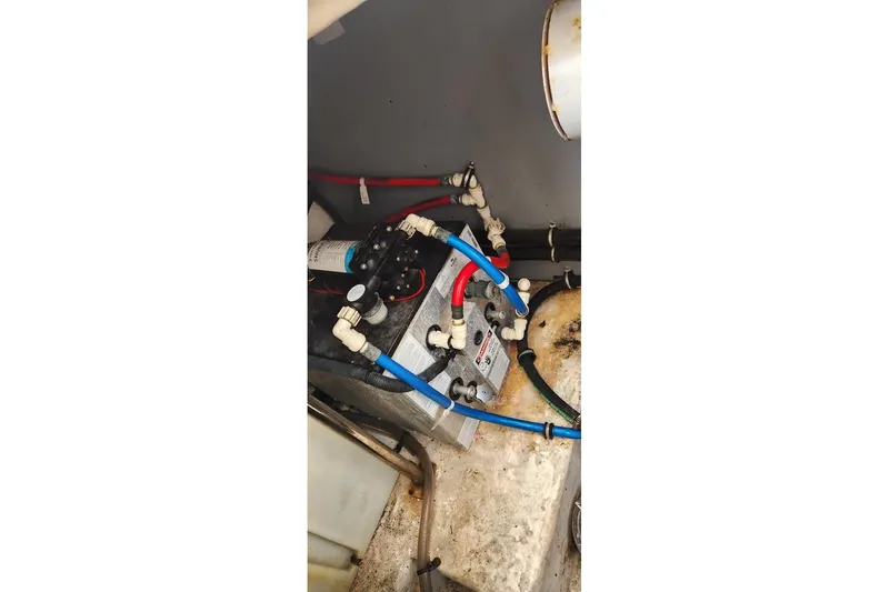 Slide: The Image of Engine compartment of a 2015 Monterey 335 Sport Yacht with visible wiring and components. - 16