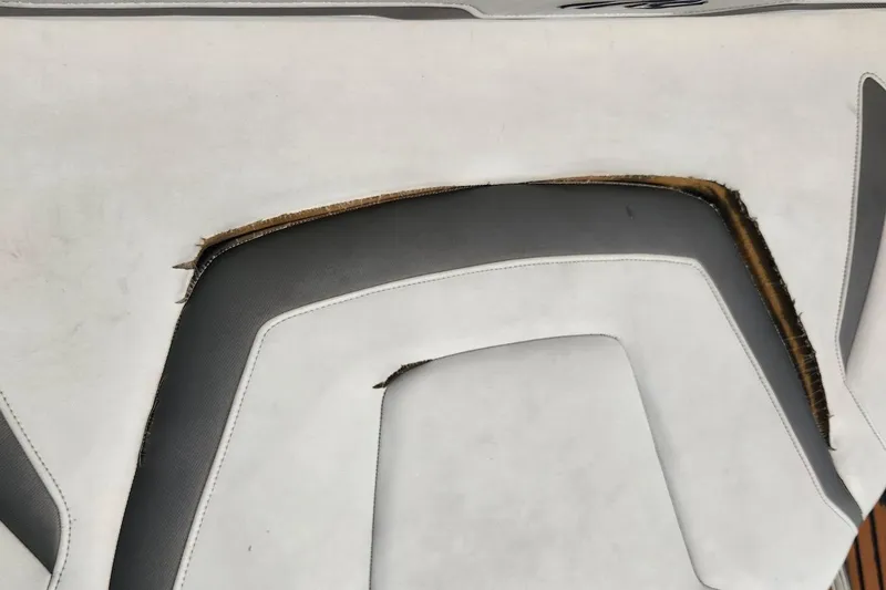 Slide: The Image of Damaged upholstery on 2015 Monterey 335 Sport Yacht seat, showing wear and tear. - 17