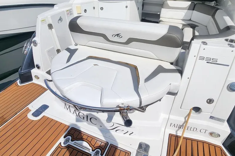 Slide: The Image of 2015 Monterey 335 Sport Yacht, rear seating area with elegant white and gray upholstery. - 3