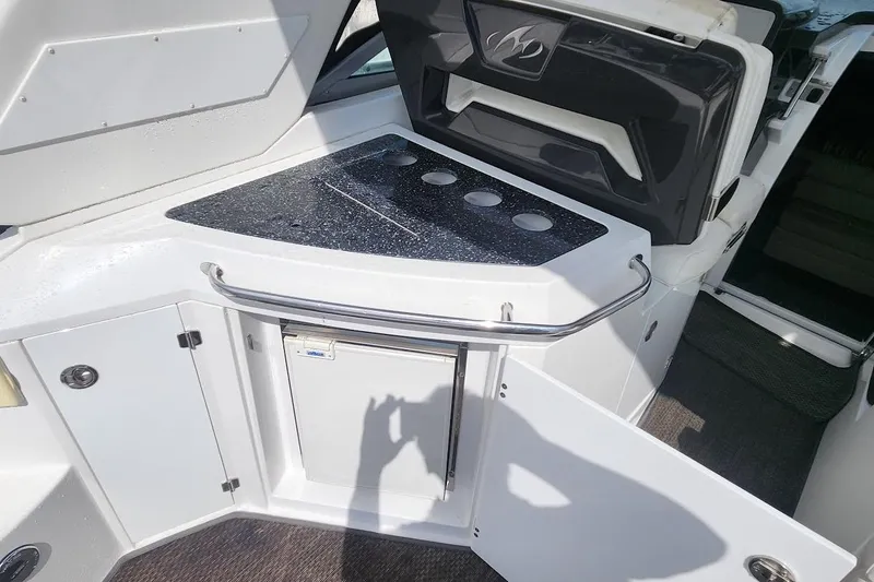 Slide: The Image of 2015 Monterey 335 Sport Yacht kitchenette with countertop, storage, and mini fridge. - 4