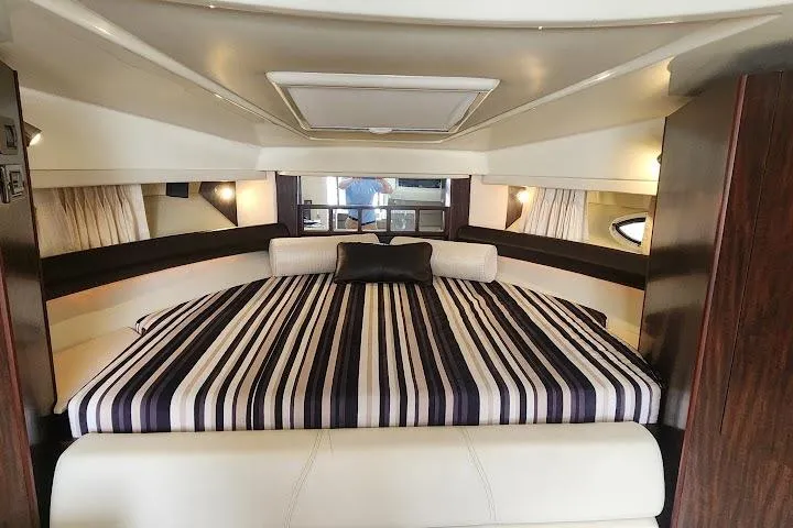 Slide: The Image of Luxurious interior of 2015 Monterey 335 Sport Yacht with striped bedding and elegant design. - 9
