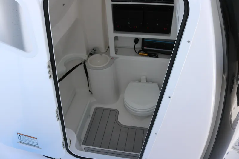 Slide: The Image of 2026 Sea Fox 288 Commander boat interior with compact marine toilet and storage. - 10