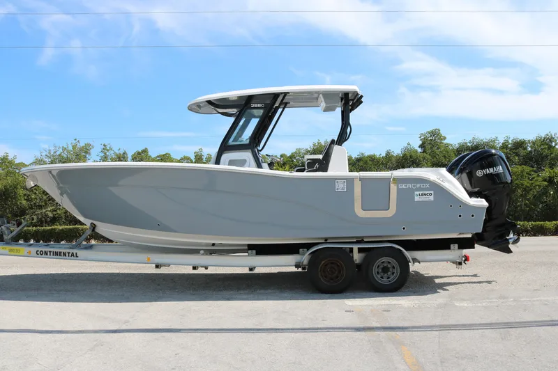 Slide: The Image of 2026 Sea Fox 288 Commander boat on trailer, side view, outdoors. - 2