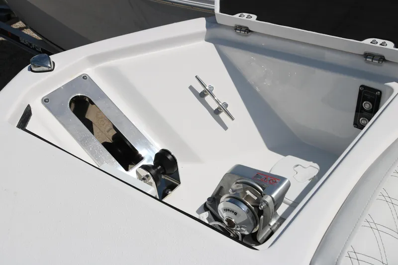 Slide: The Image of Anchor compartment of 2026 Sea Fox 288 Commander boat, featuring a polished metal winch. - 7