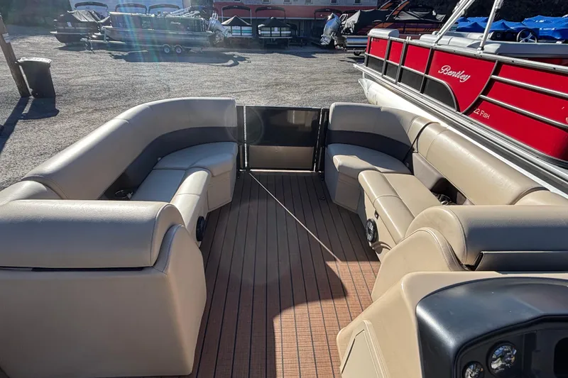 Slide: The Image of 2023 Bentley Pontoons 220 Navigator interior with beige seating and wood flooring. - 2