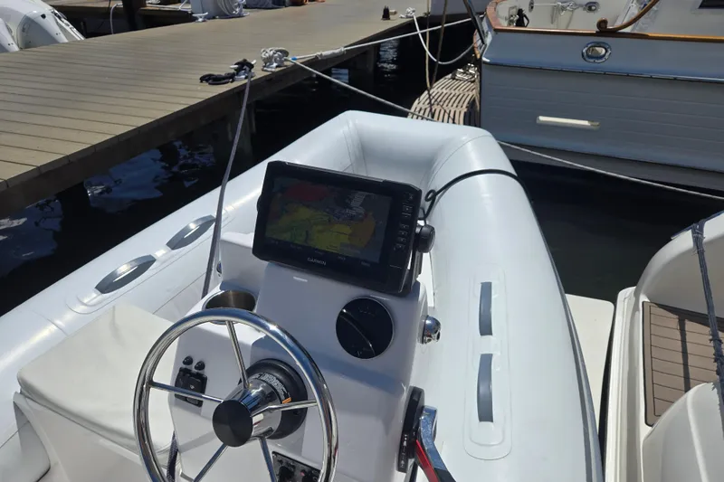Slide: The Image of 2023 AB 11 VSX boat with steering wheel and navigation display at dock. - 7