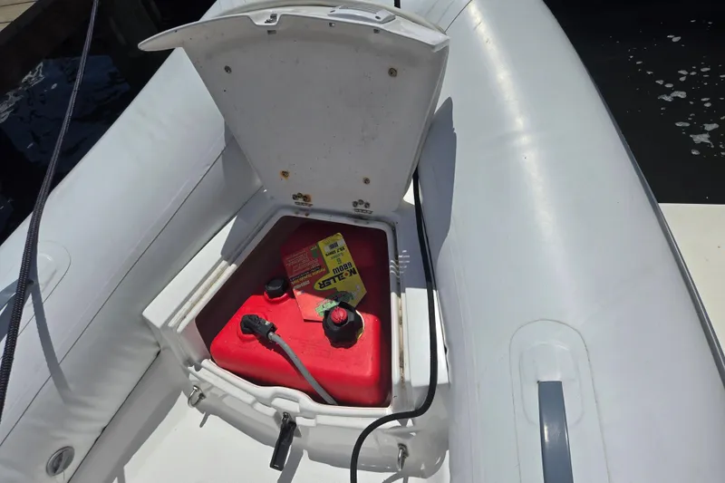 Slide: The Image of Open storage compartment on 2023 AB 11 VSX boat with red fuel tank. - 8
