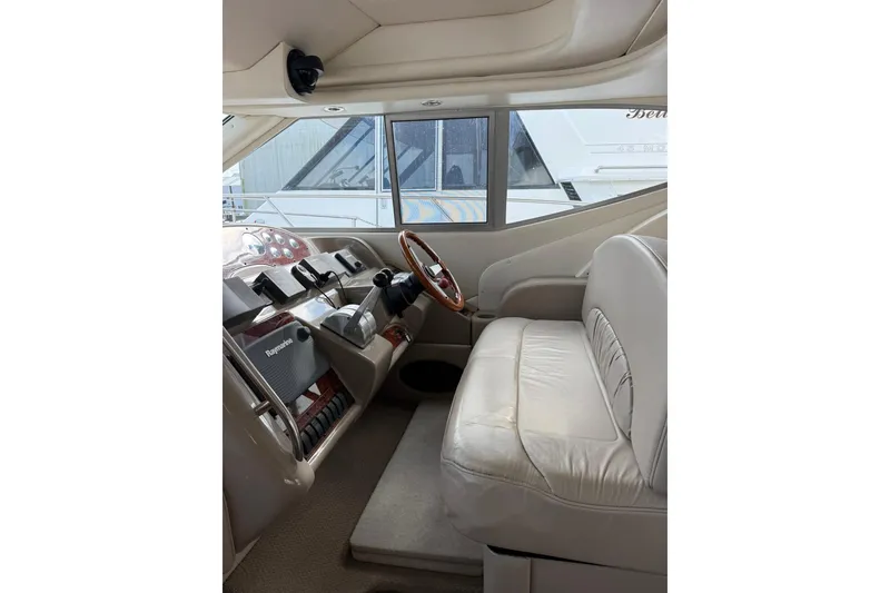 Slide: The Image of 1999 Maxum 4600 SCB yacht interior with steering wheel and leather seating. - 11