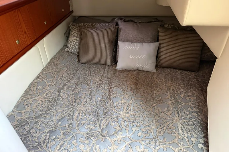 Slide: The Image of Luxurious 1999 Maxum 4600 SCB cabin with elegant bedding and decorative pillows. - 18