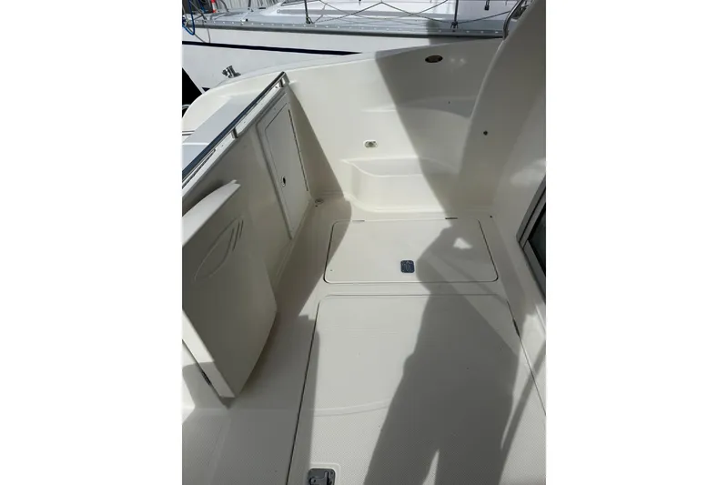 Slide: The Image of 1999 Maxum 4600 SCB boat deck with storage compartments and clean white surface. - 2