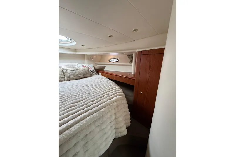 Slide: The Image of Luxurious bedroom interior of 1999 Maxum 4600 SCB yacht with plush bedding and wood accents. - 23