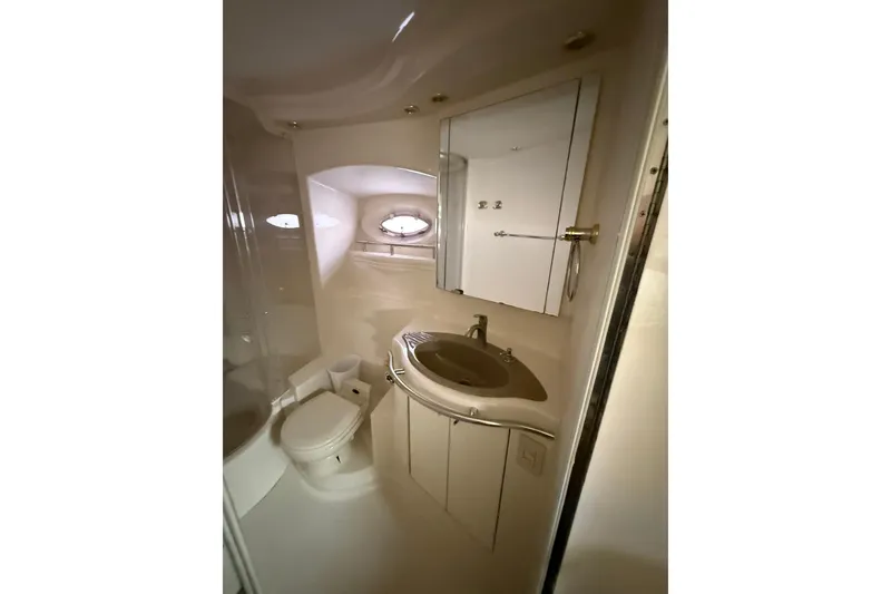 Slide: The Image of 1999 Maxum 4600 SCB yacht bathroom with sink, toilet, and mirror. - 26