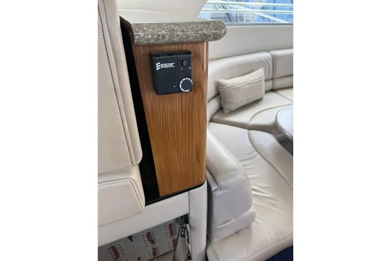 Slide: The Image of 1999 Maxum 4600 SCB yacht interior with Espar control panel and luxurious seating. - 27