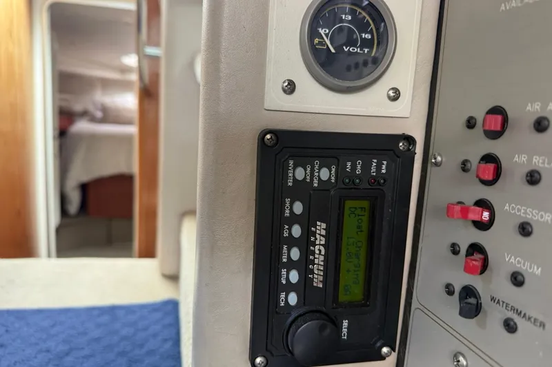 Slide: The Image of 1999 Maxum 4600 SCB yacht control panel with voltmeter and Magnum inverter display. - 28