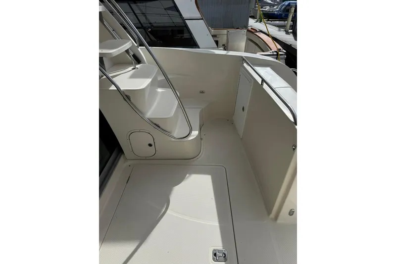 Slide: The Image of 1999 Maxum 4600 SCB yacht deck with stairs and railing, docked in marina. - 3