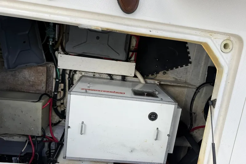 Slide: The Image of Engine compartment of a 1999 Maxum 4600 SCB boat, showing mechanical components and wiring. - 30