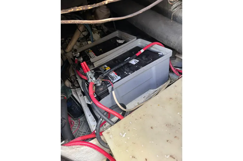 Slide: The Image of Battery compartment of a 1999 Maxum 4600 SCB with red and black cables. - 37