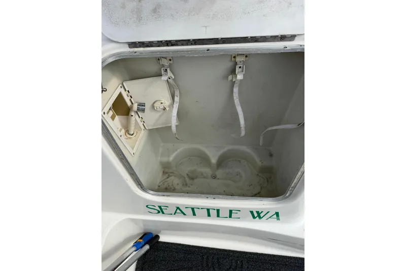 Slide: The Image of Open storage compartment on 1999 Maxum 4600 SCB boat, labeled "Seattle WA." - 7