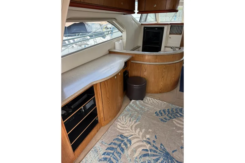 Slide: The Image of 1999 Maxum 4600 SCB yacht interior with wood cabinetry and modern appliances. - 8