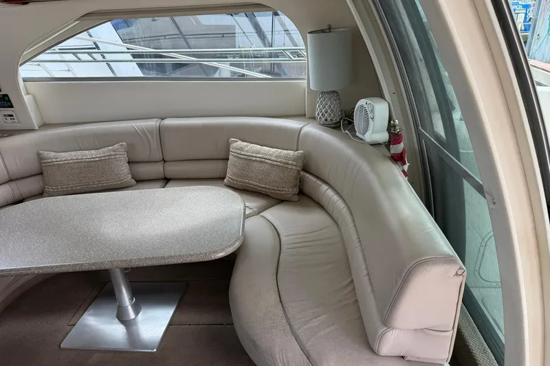 Slide: The Image of Luxurious interior of 1999 Maxum 4600 SCB yacht with curved seating and table. - 9