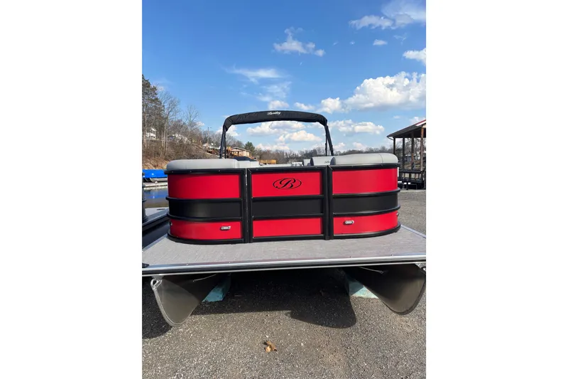 The Image of 2026 Bentley Pontoons Legacy 220 Cruise XL, red and black design, docked under blue sky. - 0