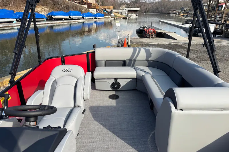 Slide: The Image of 2026 Bentley Pontoons Legacy 220 Cruise XL with spacious seating, docked by a serene lake. - 5