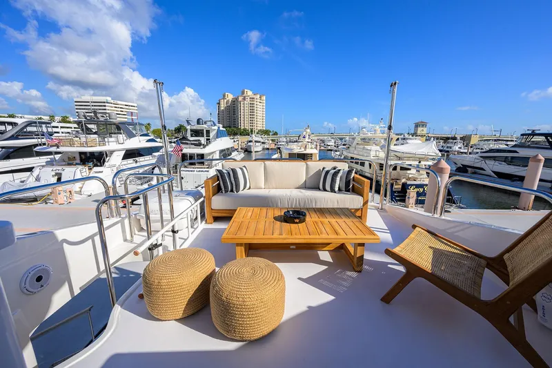 Slide: The Image of Luxurious 2005 Lazzara 68 Enclosed Bridge yacht with elegant outdoor seating at marina. - 12