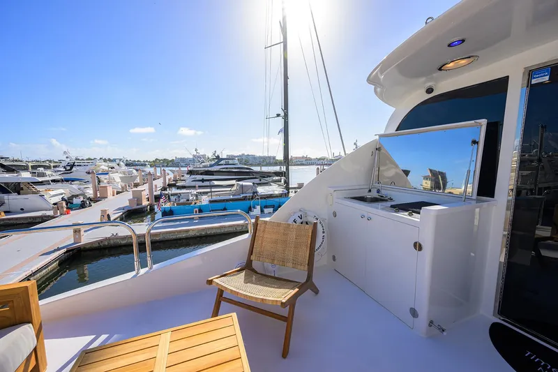 Slide: The Image of Luxurious 2005 Lazzara 68 Enclosed Bridge yacht docked at marina under sunny sky. - 14