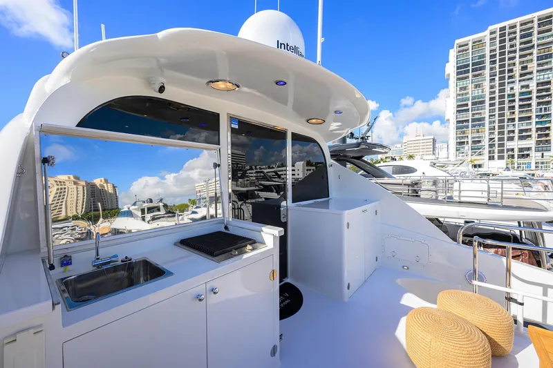 Slide: The Image of 2005 Lazzara 68 Enclosed Bridge yacht deck with outdoor kitchen and cityscape view. - 15