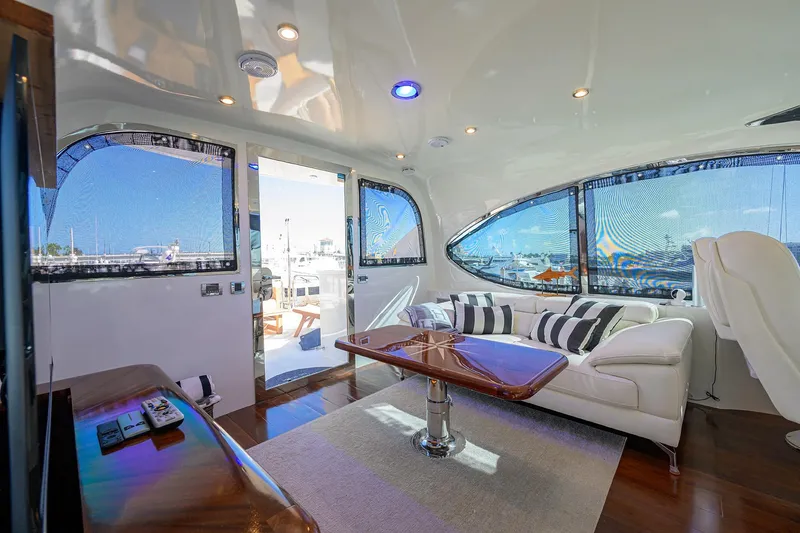 Slide: The Image of Luxurious interior of 2005 Lazzara 68 Enclosed Bridge yacht with modern seating and panoramic windows. - 17