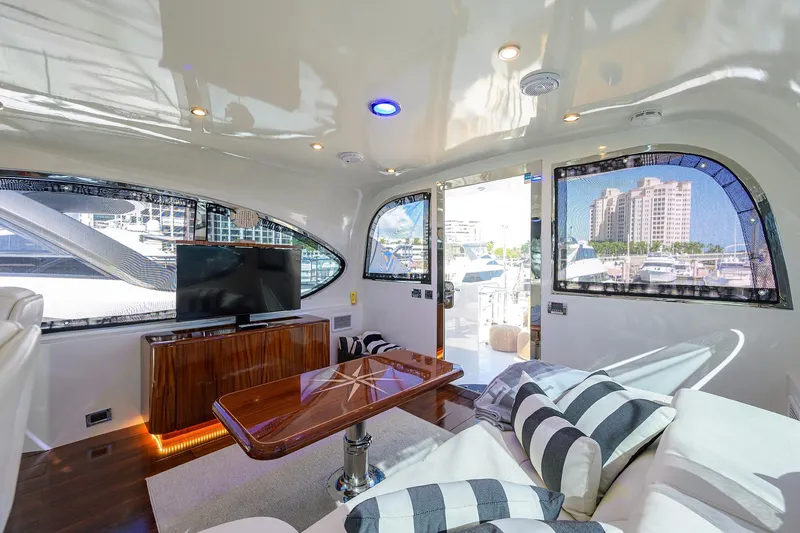 Slide: The Image of Luxurious interior of 2005 Lazzara 68 Enclosed Bridge yacht with modern furnishings and marina view. - 19