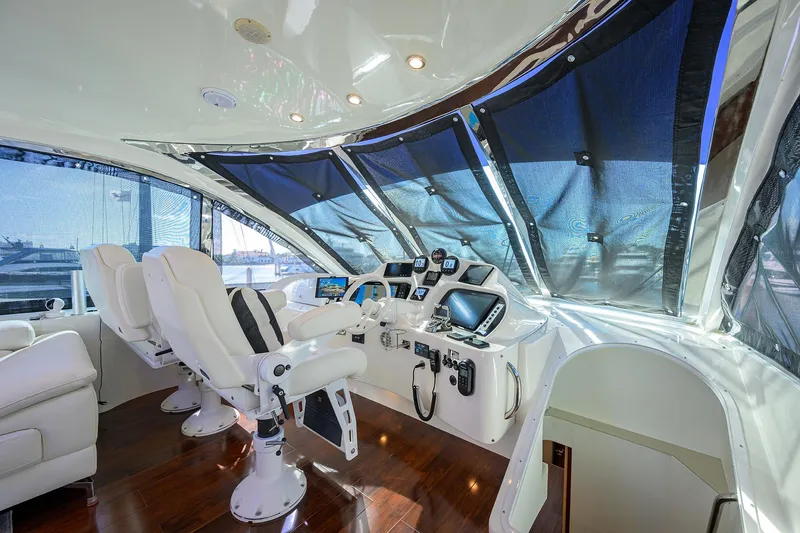 Slide: The Image of Luxurious helm of 2005 Lazzara 68 Enclosed Bridge yacht with modern navigation equipment. - 22