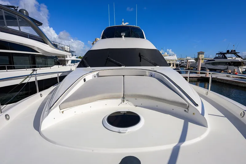 Slide: The Image of 2005 Lazzara 68 Enclosed Bridge yacht docked at marina under clear blue sky. - 27