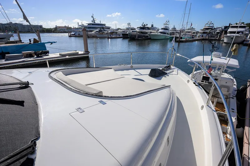 Slide: The Image of 2005 Lazzara 68 Enclosed Bridge yacht docked in a marina under clear skies. - 29