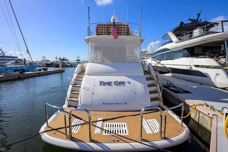 Slide: The Image of 2005 Lazzara 68 Enclosed Bridge yacht docked at marina, rear view. - 3