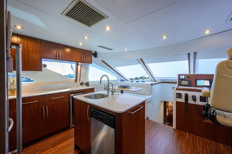 Slide: The Image of Luxurious interior of 2005 Lazzara 68 Enclosed Bridge yacht with modern kitchen and helm. - 38