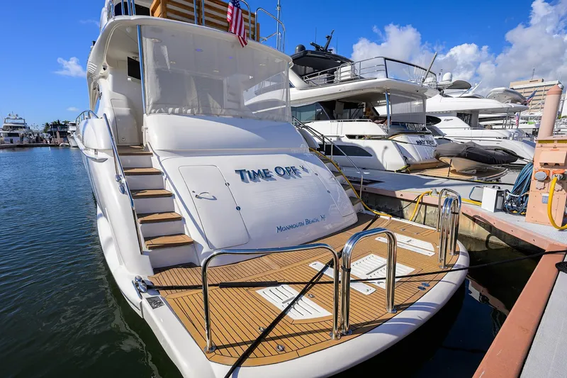 Slide: The Image of 2005 Lazzara 68 Enclosed Bridge yacht docked at marina, sunny day. - 4