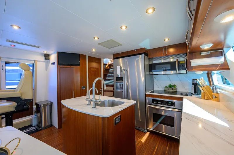 Slide: The Image of Luxurious kitchen interior of 2005 Lazzara 68 Enclosed Bridge yacht with modern appliances. - 41