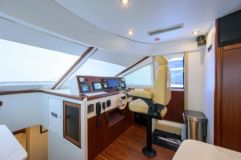 Slide: The Image of Interior helm of 2005 Lazzara 68 Enclosed Bridge yacht with modern controls and captain's chair. - 45