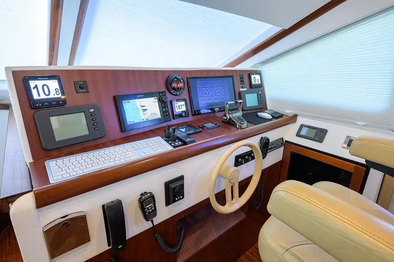 Slide: The Image of 2005 Lazzara 68 Enclosed Bridge helm with advanced navigation and control systems. - 46
