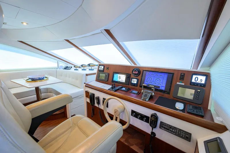 Slide: The Image of Luxurious 2005 Lazzara 68 Enclosed Bridge yacht interior with modern navigation equipment. - 48