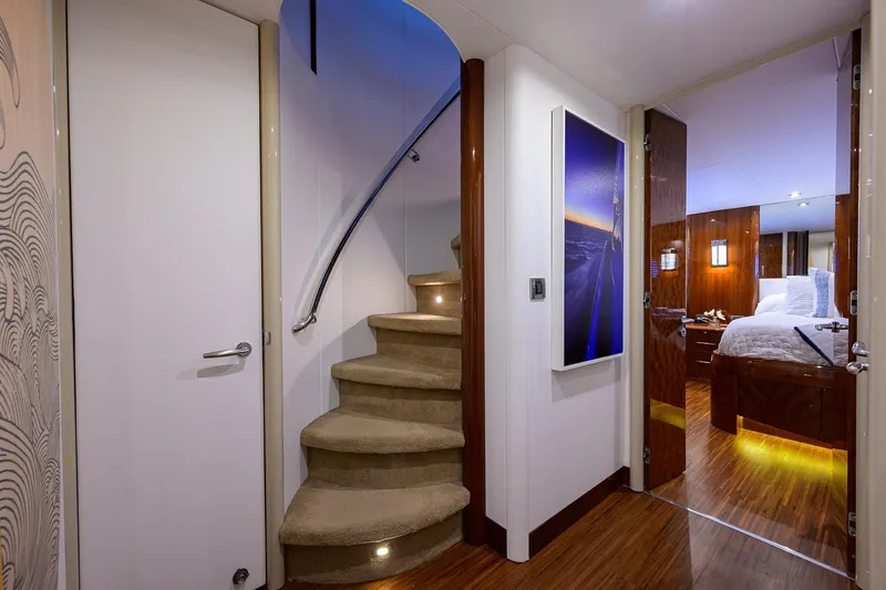 Slide: The Image of Luxurious interior of 2005 Lazzara 68 Enclosed Bridge yacht with elegant staircase and bedroom. - 51