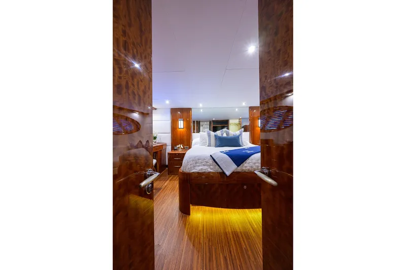 Slide: The Image of Luxurious bedroom interior of 2005 Lazzara 68 Enclosed Bridge yacht with elegant wood finishes. - 52