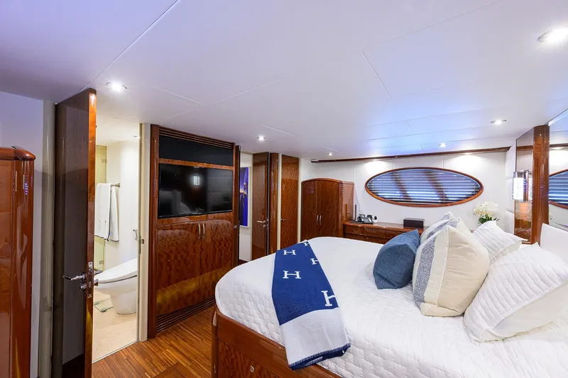 Slide: The Image of Luxurious bedroom interior of 2005 Lazzara 68 Enclosed Bridge yacht with elegant wood finishes. - 54